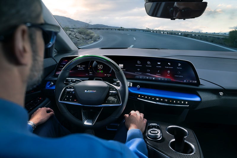 Front View of the 2026 OPTIQ-V Driving Through the Dusk Utilizing its Headlights | Morris Cadillac in NORTH OLMSTED OH